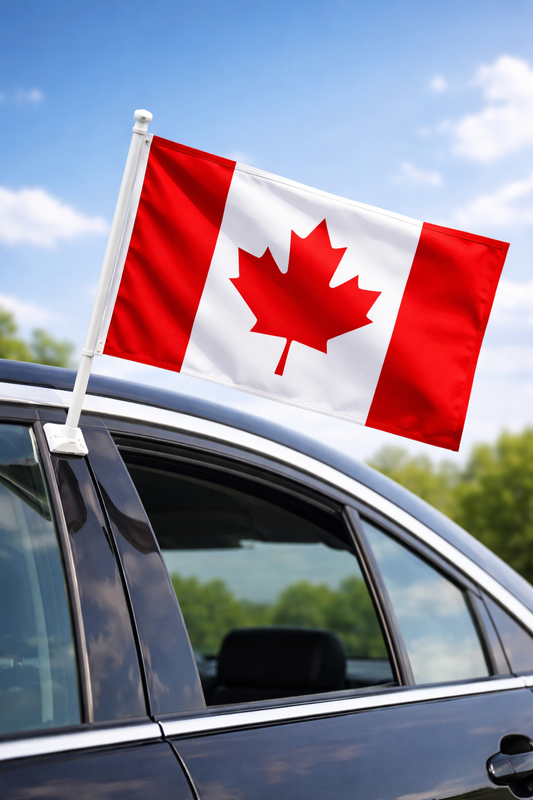 Canadian flag on a car with a clear blue sky background
