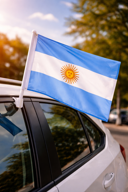 Argentine flag on a car window with trees and sky in the background